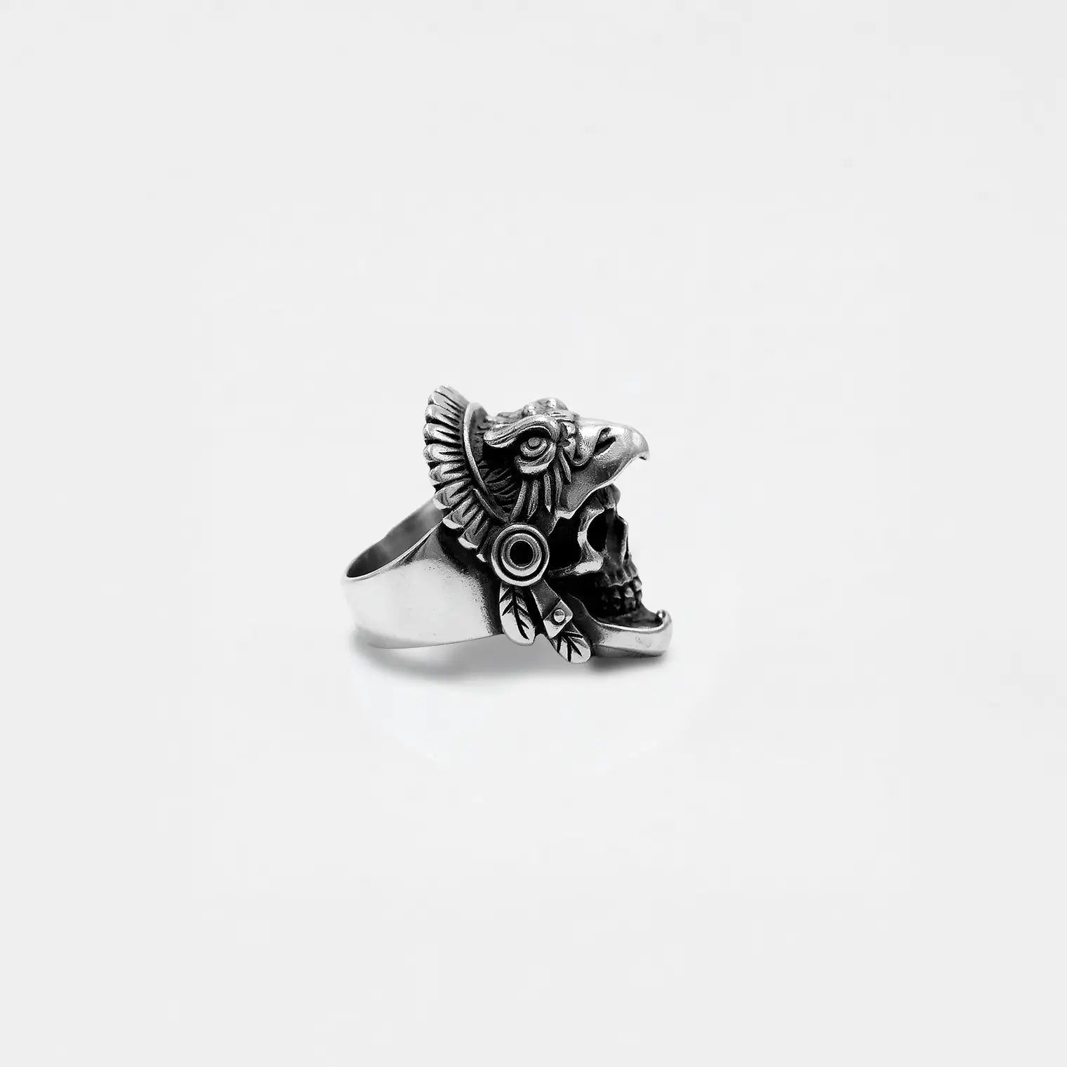 Silver EAGLE-WARRIOR skull ring on a light gray background