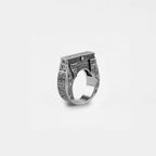 Silver ring with egyptian architecture design on a white background