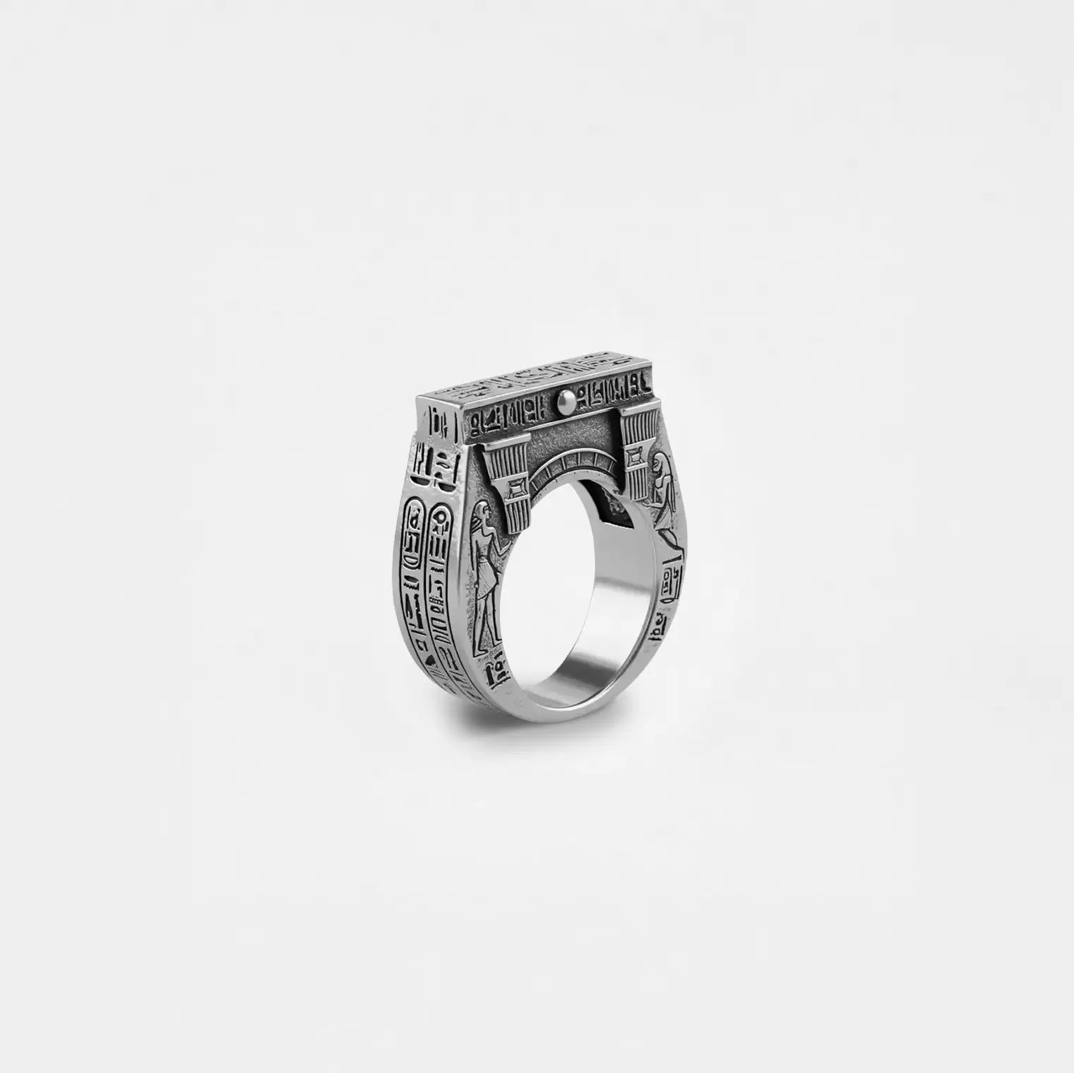 Silver ring with egyptian architecture design on a white background