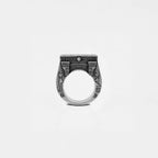 Silver ring with egyptian architecture design on a white background