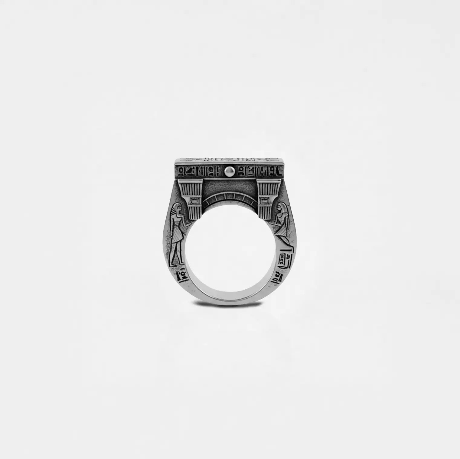 Silver ring with egyptian architecture design on a white background
