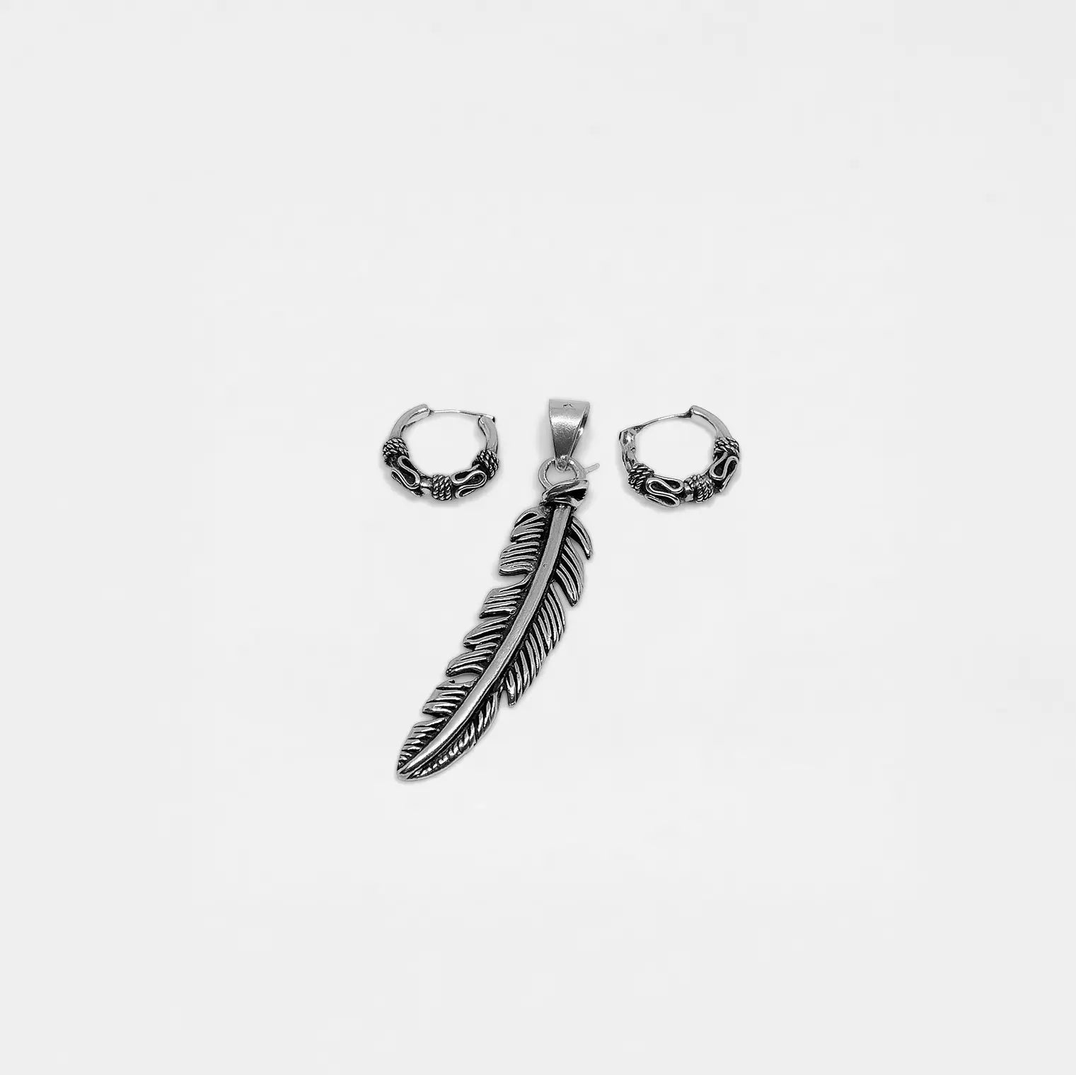 Silver feather hoop earrings on a white background