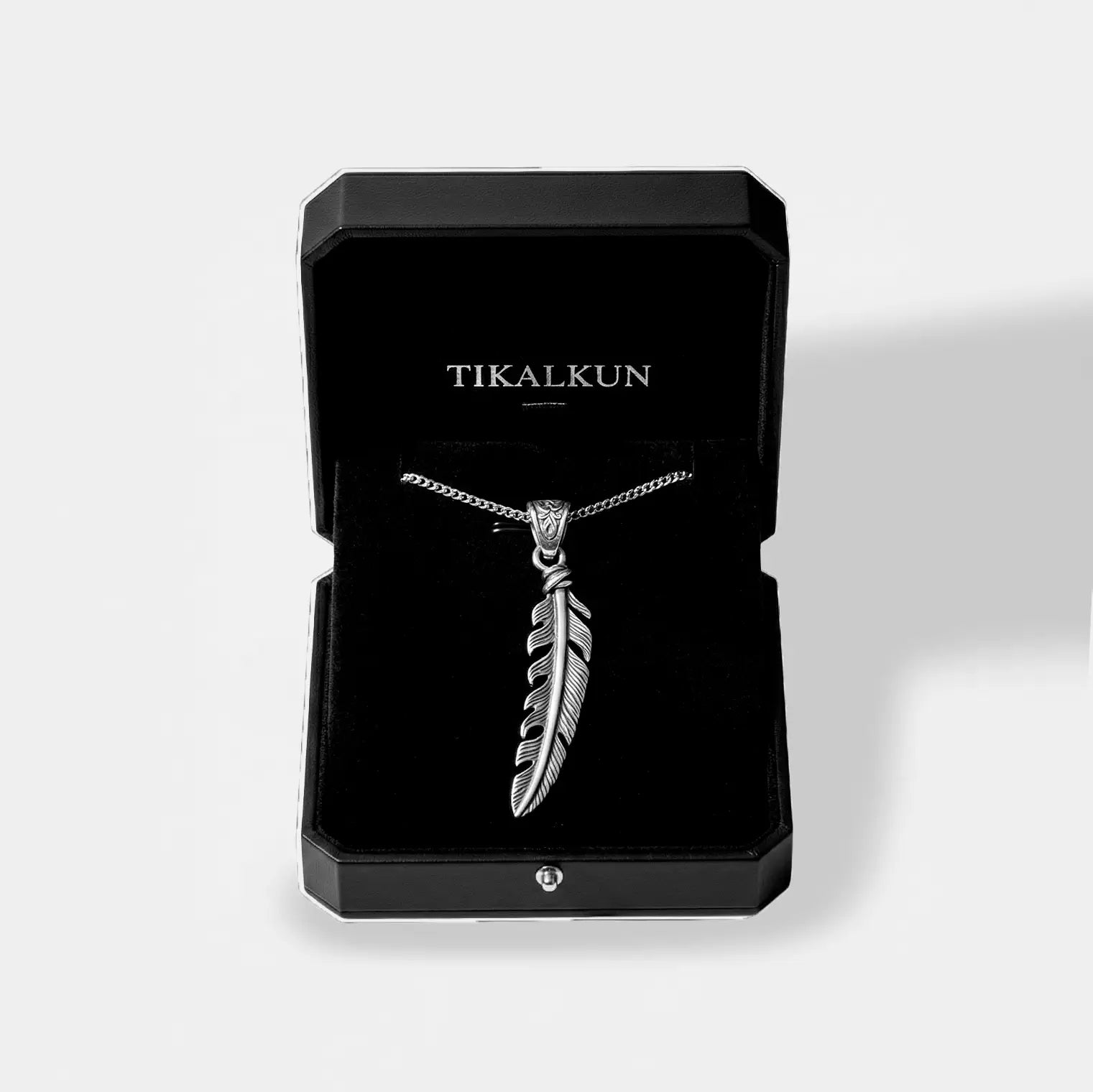 Silver feather necklace in a black Tikalkun box on a white background