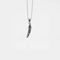 Silver feather pendant necklace on a white background