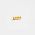 Gold crown ring with gemstones on a light gray background