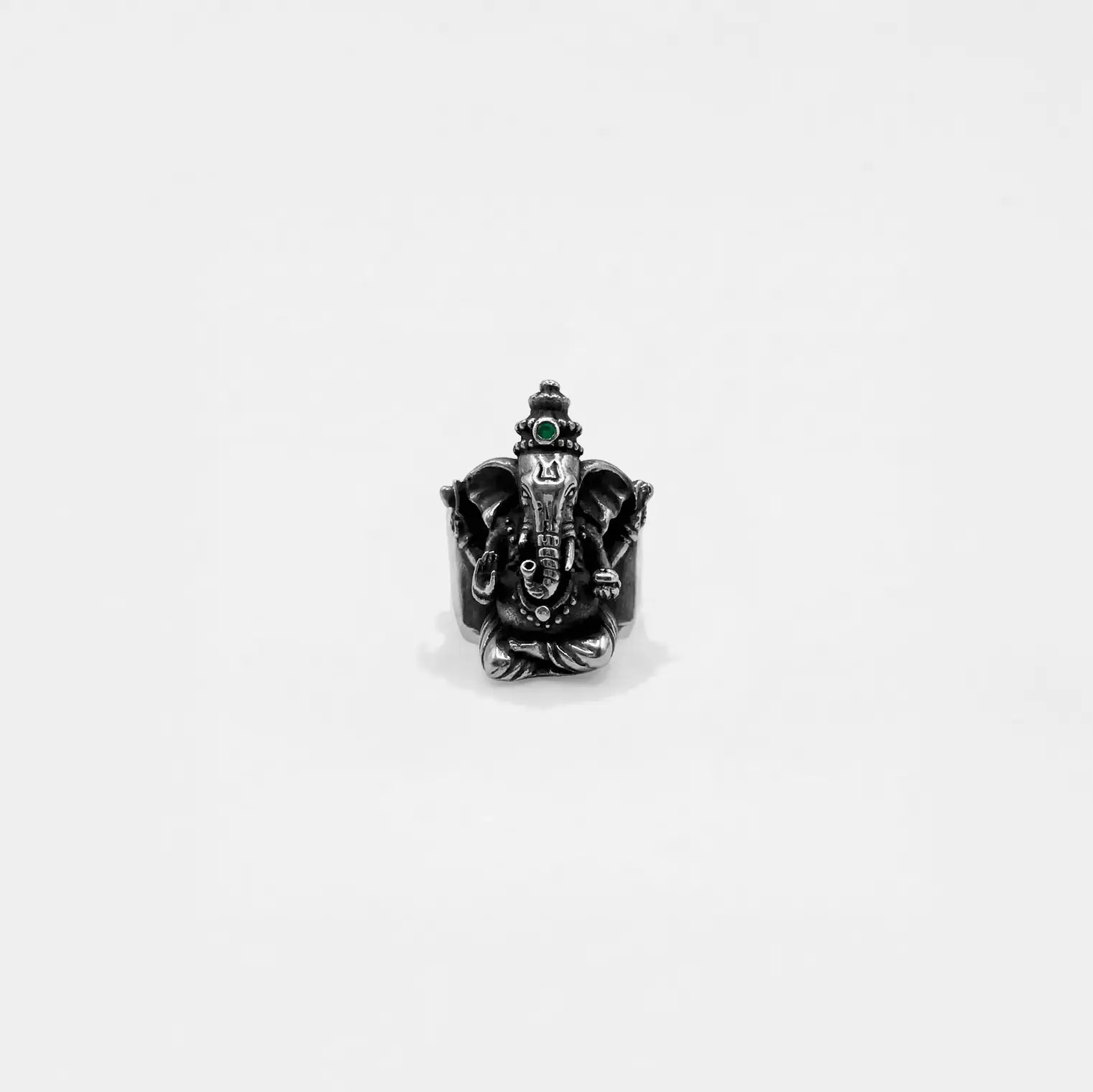Black ring with a ganesha design on a white background