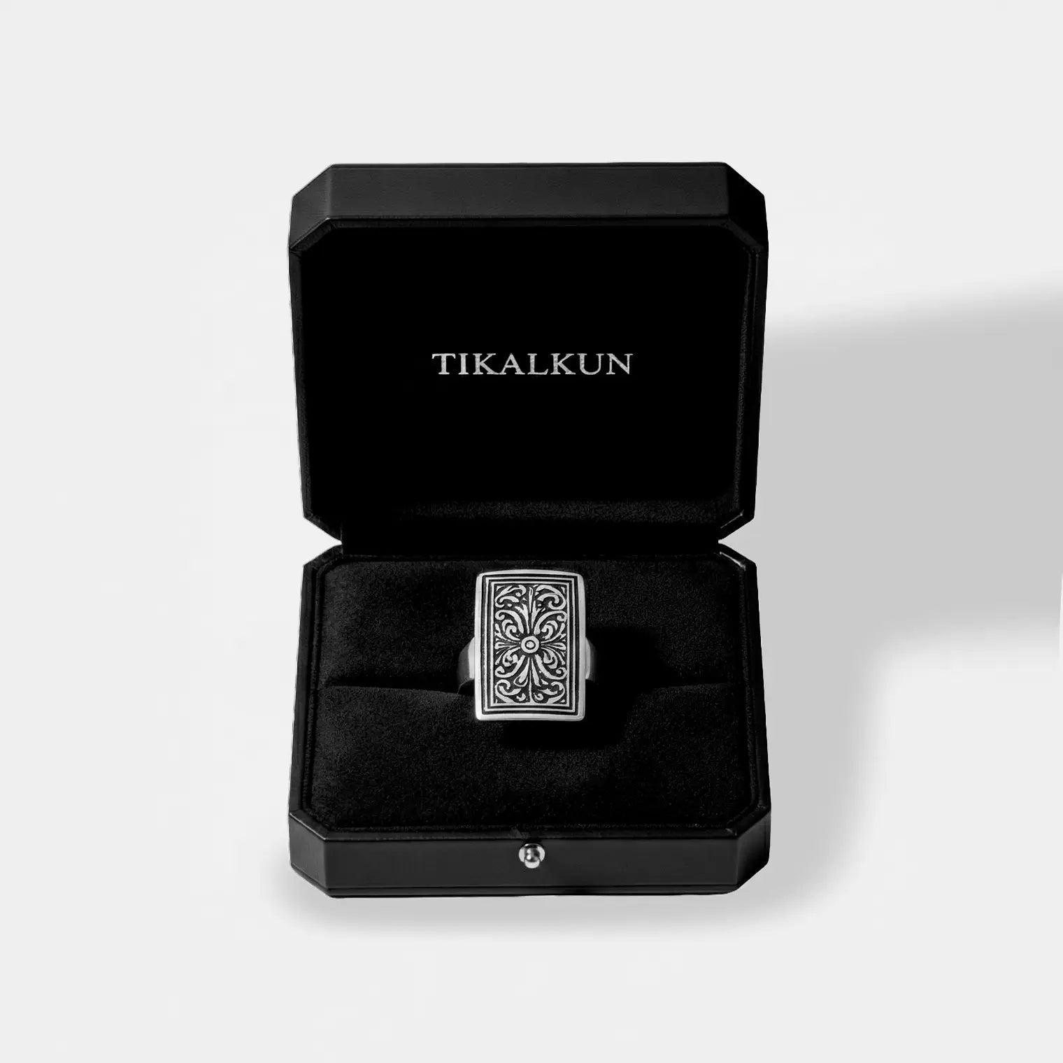 black TIKALKUN jewelry  box with a mexican silver ring inside it, on a white background