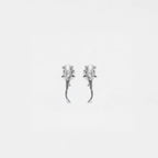 Pair of silver  hammerhead-shark earrings on a light gray background
