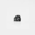 Silver ring with aztec god design on a white background