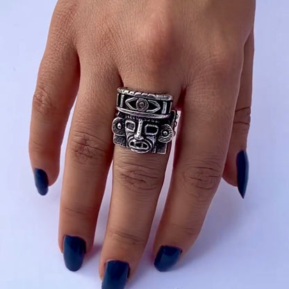 hand wearing aztec god silver ring
