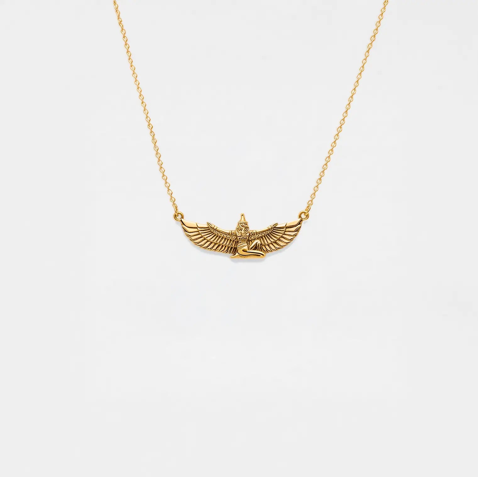 Gold necklace with an egyptian pendant on a white background