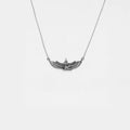 Silver necklace with an egyptian pendant on a white background