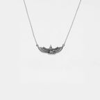 Silver necklace with an egyptian pendant on a white background