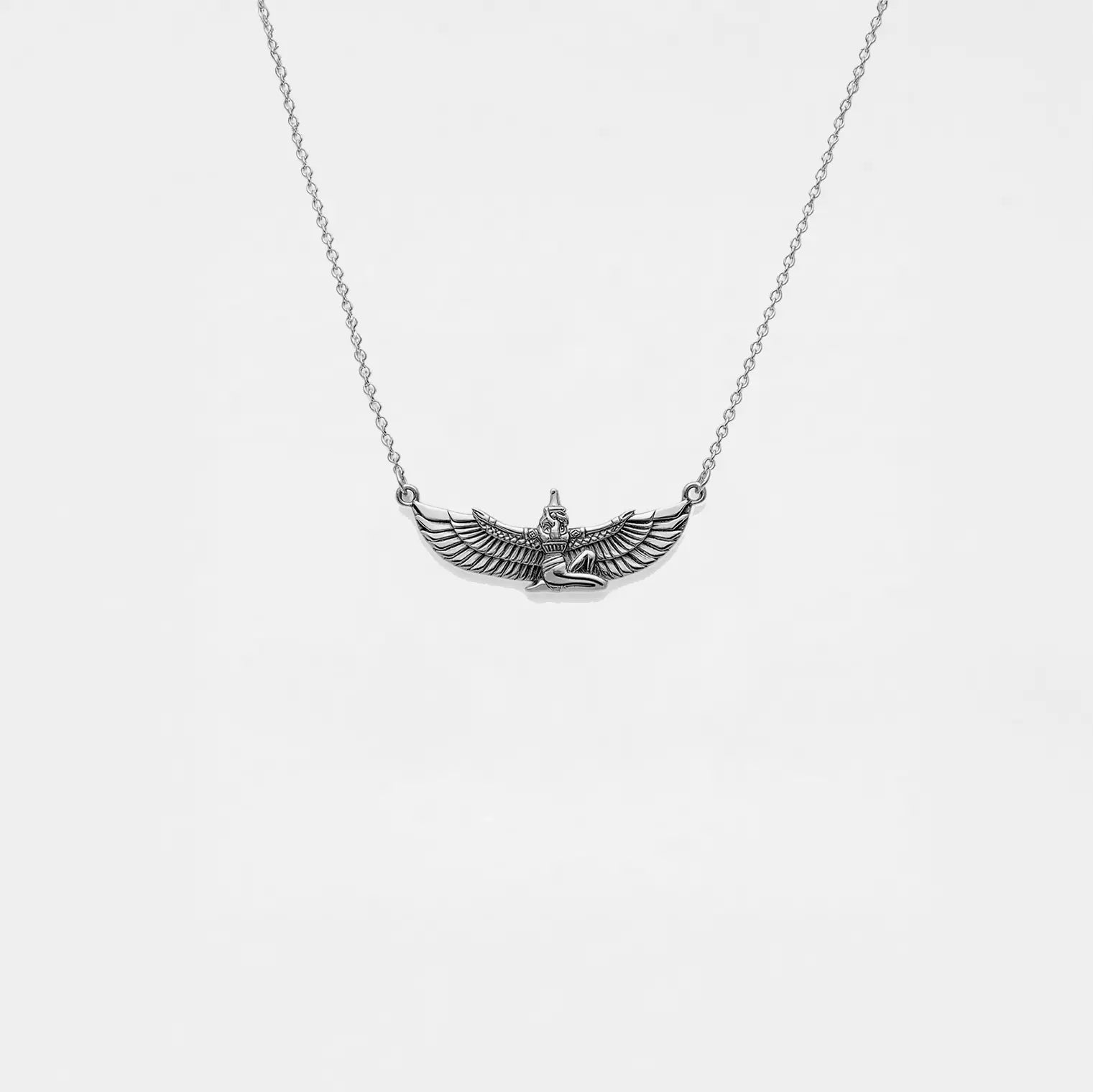 Silver necklace with an egyptian pendant on a white background