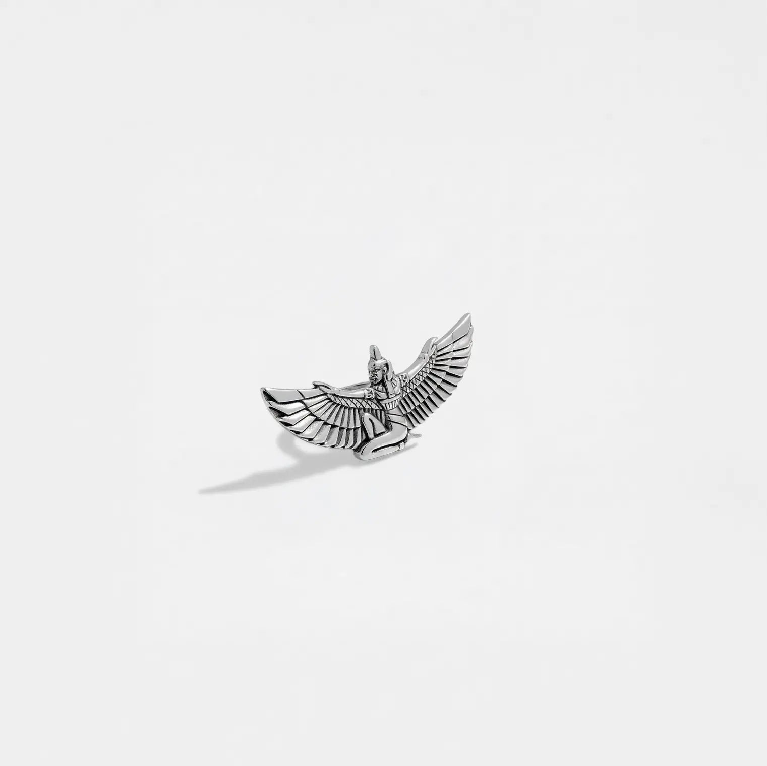 Silver isis figurine on a white background