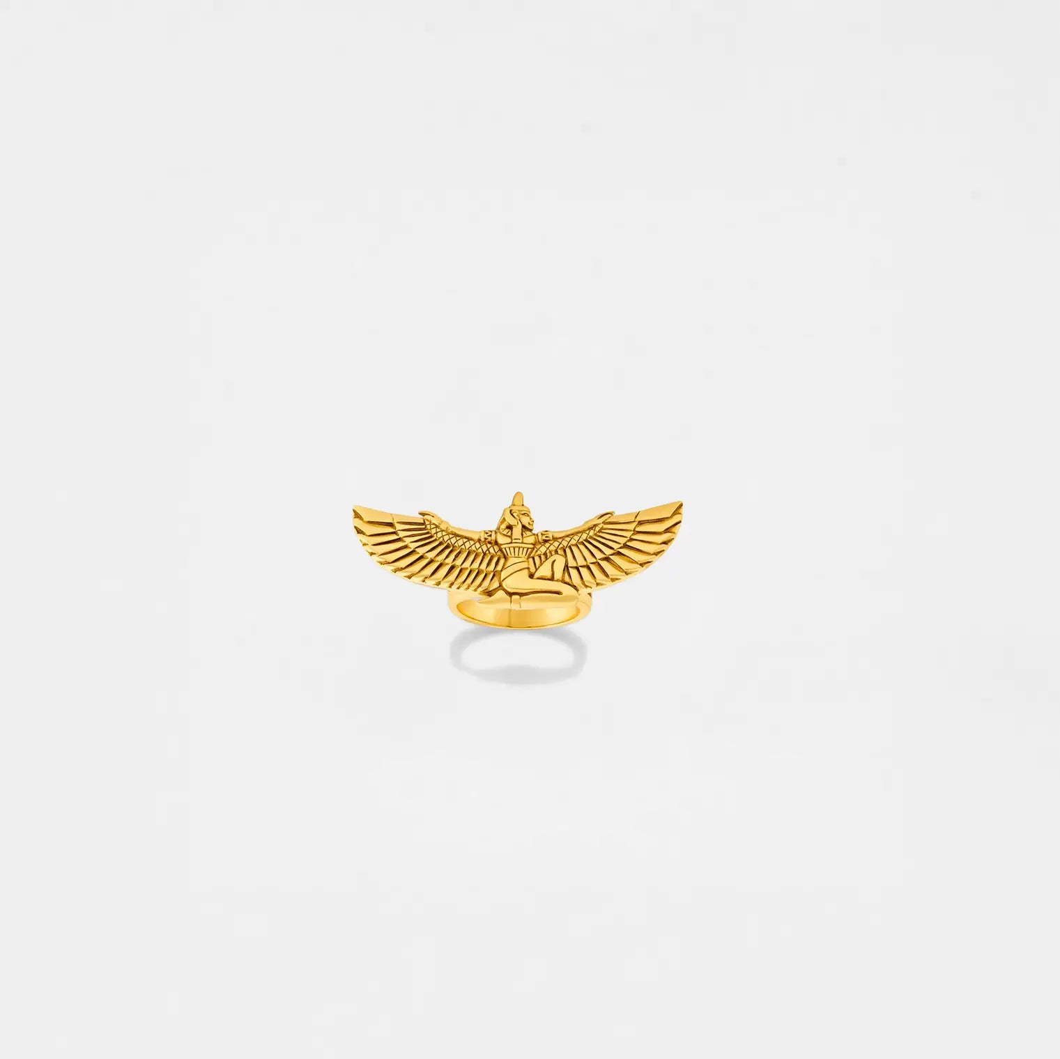 Gold isis-shaped pendant on a light gray background