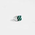 Silver ring with green stone on a white background