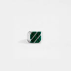 Silver ring with green gemstone on a white background