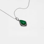 Necklace with a jade teardrop pendant on a white background