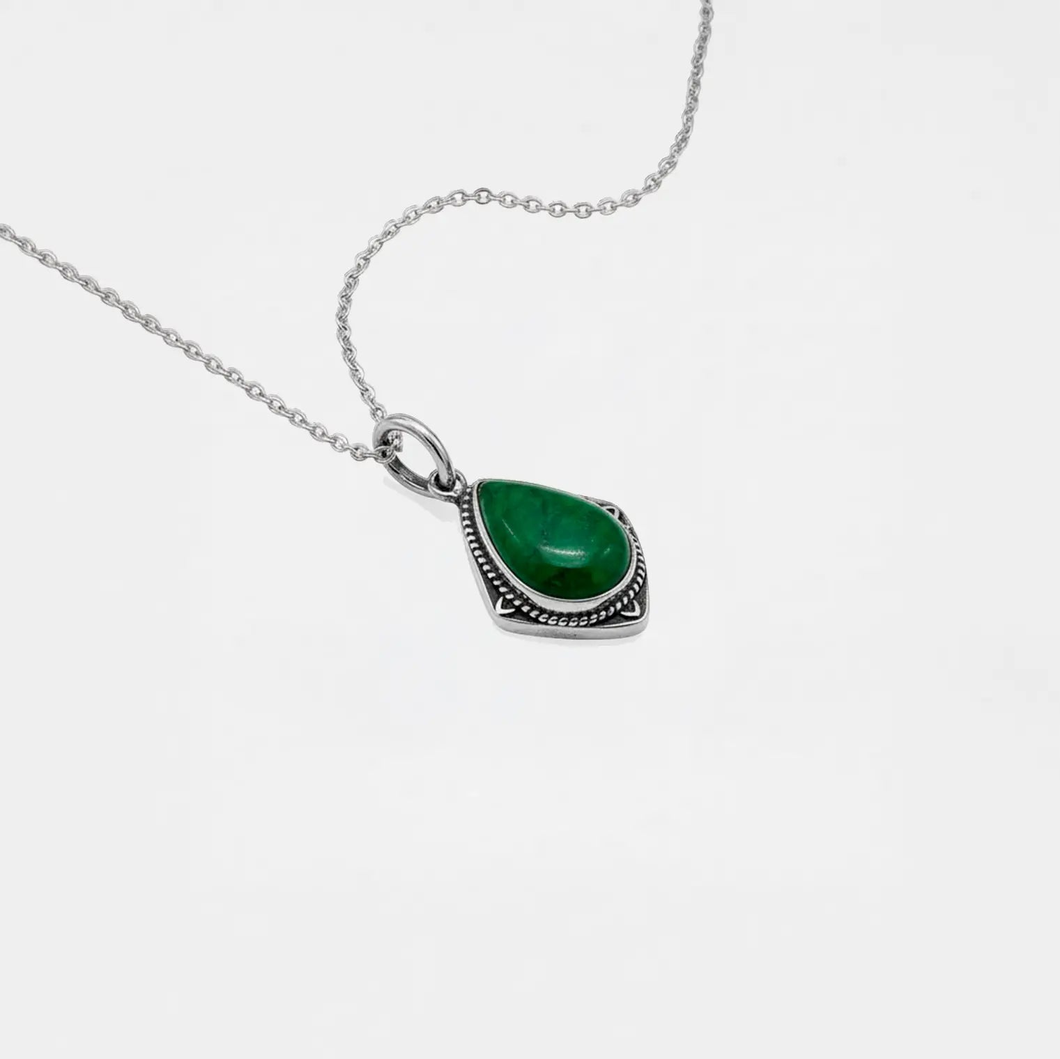 Necklace with a jade teardrop pendant on a white background