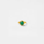 Gold ring with a jade gemstone on a white background