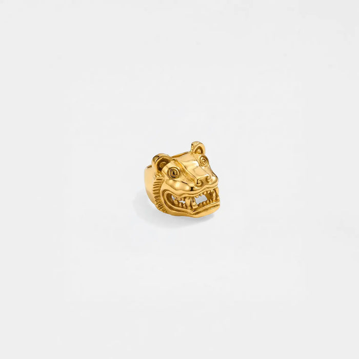 Gold ring with a jaguar head design on a light gray background