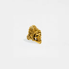 Gold jaguar-warrior skull ring on a light gray background