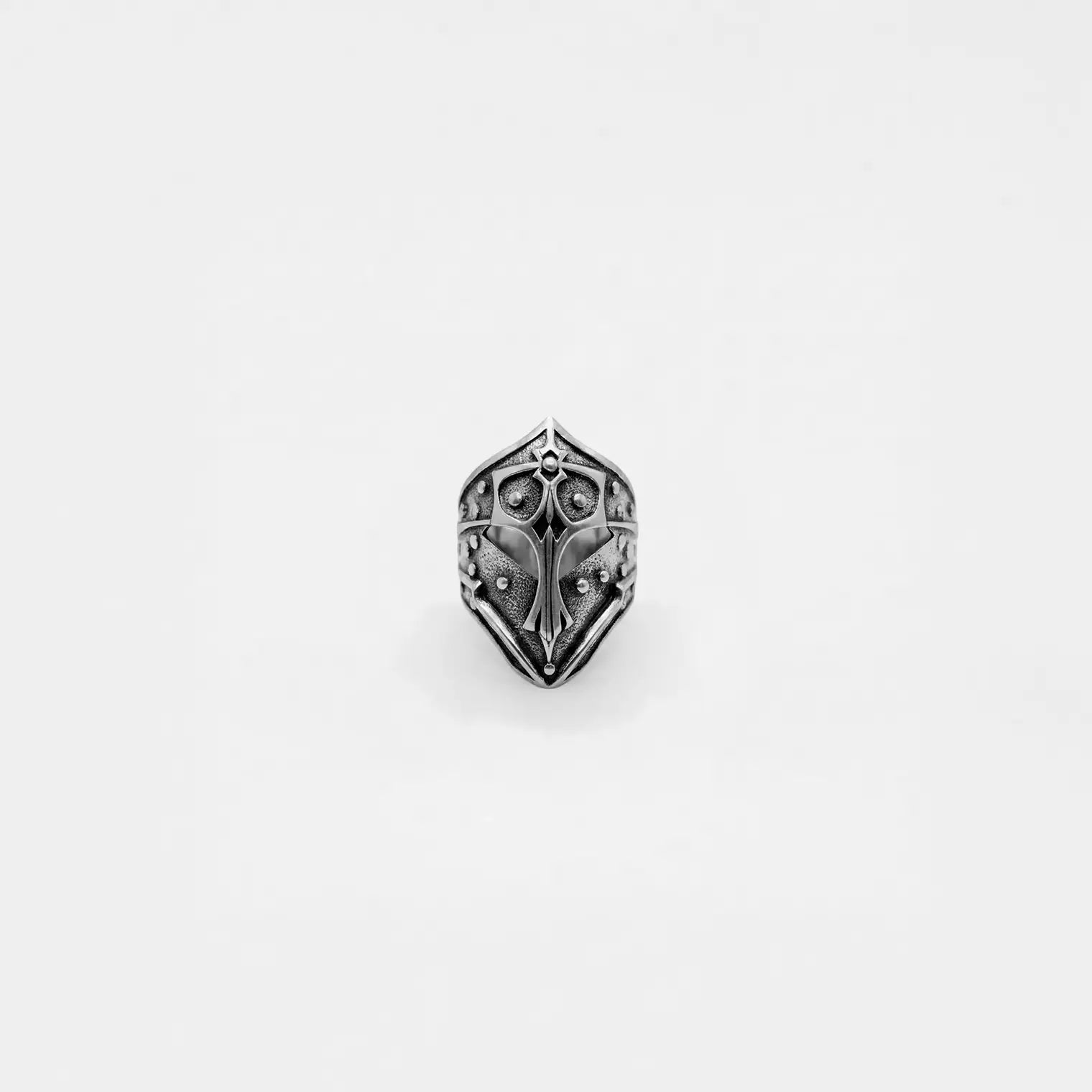 Silver knight's helmet ring on a white background