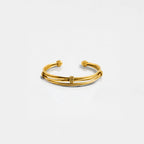 Gold bracelet on a light gray background