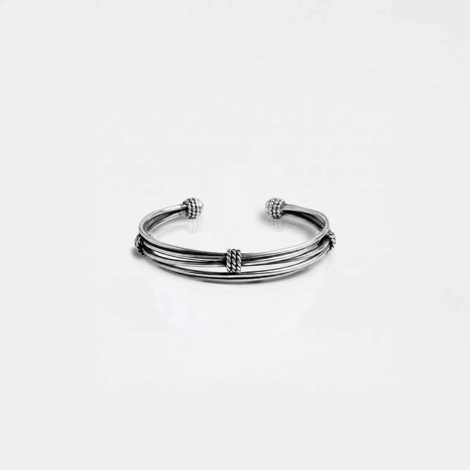 Silver bracelet on a light gray background