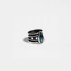 Silver ring with a labradorite stone on a light gray background