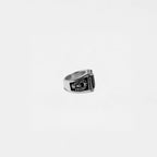 Silver ring with a black engraving on a white background