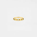 lunar cycle Gold ring with a central gemstone on a light gray background