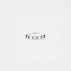 Silver ring of the lunar phase with a stone on a light gray background