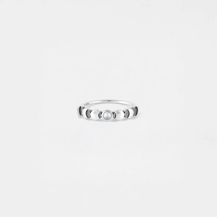Silver ring of the lunar phase with a stone on a light gray background