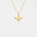 Gold MANTA RAY necklace on a light gray background