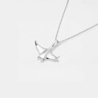 Silver necklace with a manta ray pendant on a light gray background