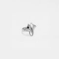 Silver ring with a manta ray design on a light gray background