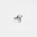 Silver ring with a manta ray design on a light gray background