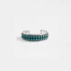 Silver bracelet with turquoise stones on a white background