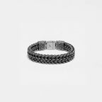 Silver braided bracelet on a light gray background