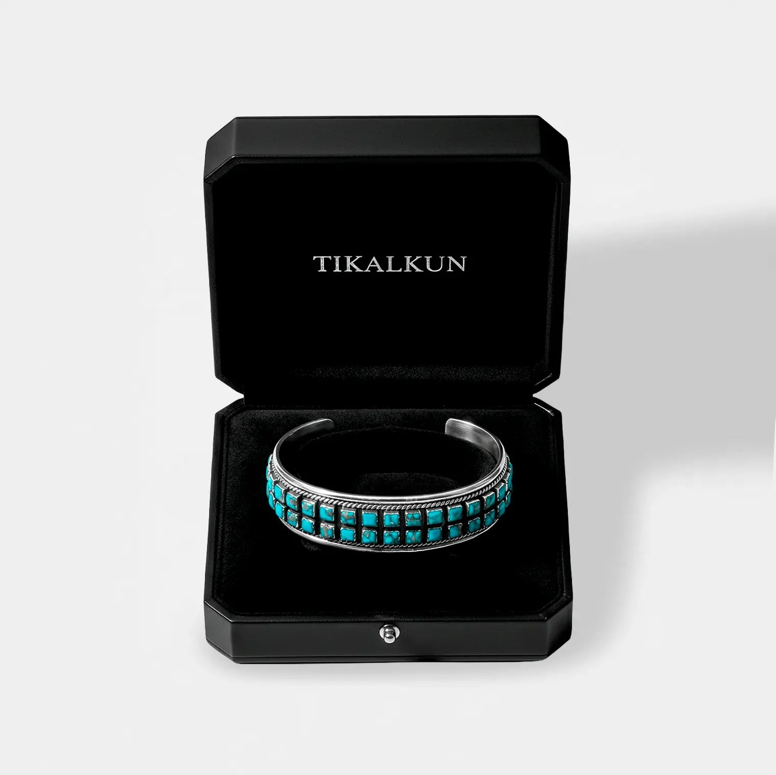 Turquoise bracelet in a black Tikalkun box on a white background