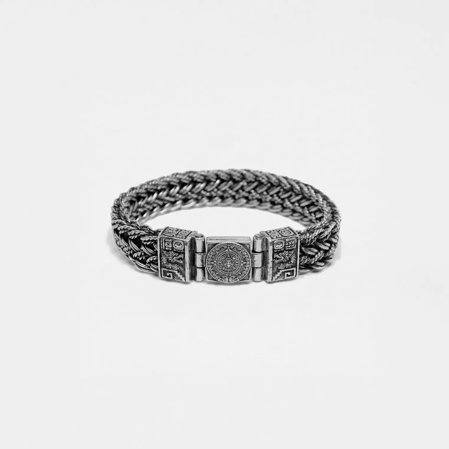 Silver bracelet with mayan design on a light gray background