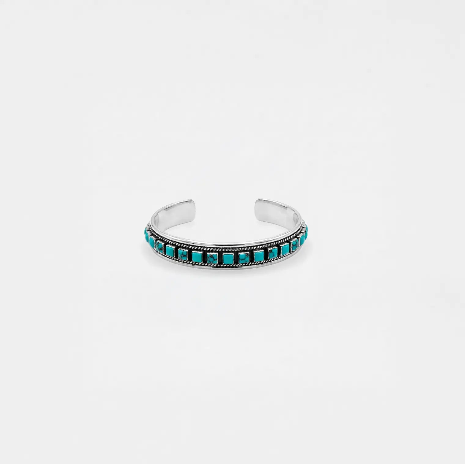 Silver bracelet with turquoise stones on a white background