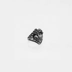 Silver ring with anatomical heart design on a light gray background