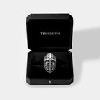 Silver medieval shield ring in a black Tikalkun box on a light gray background