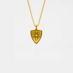 Gold necklace with a shield-shaped pendant on a white background