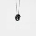 Necklace with a pendant shaped like a medusa head on a white background