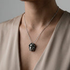 Necklace with a MEDUSA pendant worn by a person in a beige top against a neutral background