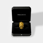 Gold aztec skull ring in a black Tikalkun box on a light gray background